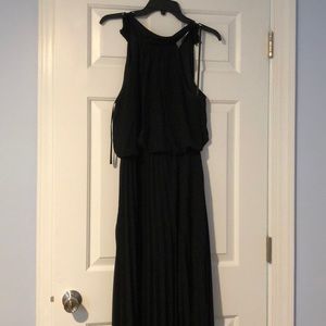 Black halter neck, pleated maxi dress.